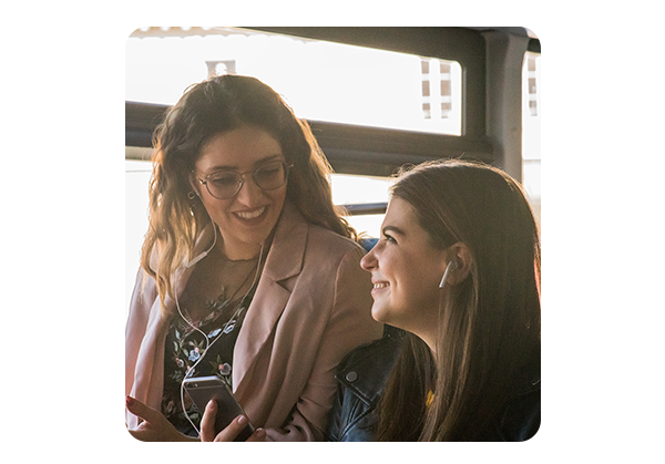 Happy friends laughing at their smartphone