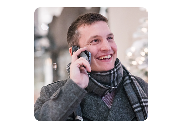 Man laughing while speaking on the phone